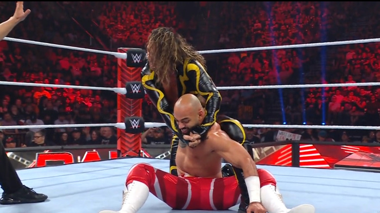 Nakamura with Ricochet locked in a hold