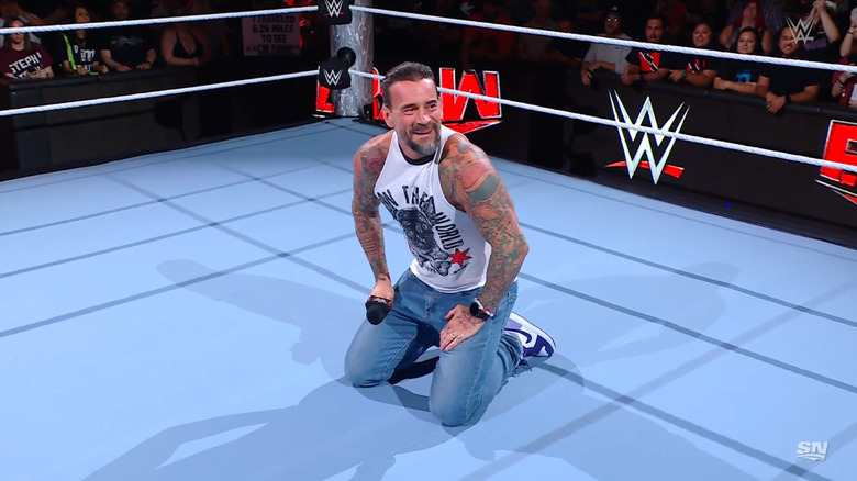 Punk kneeling in the ring