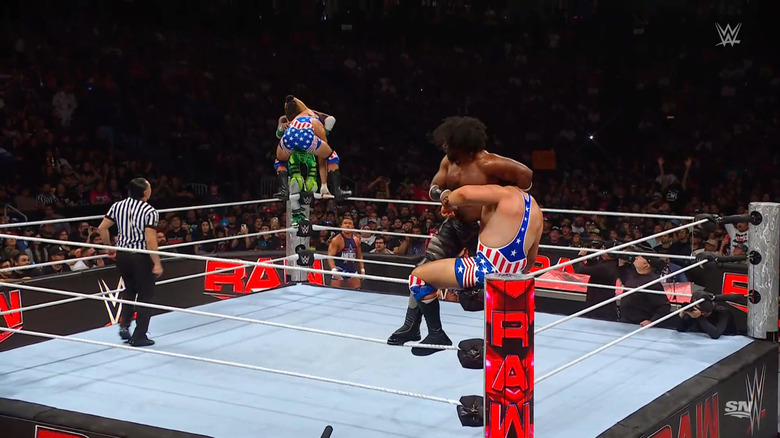 New Day and The Creed Brothers teetering on the top rope