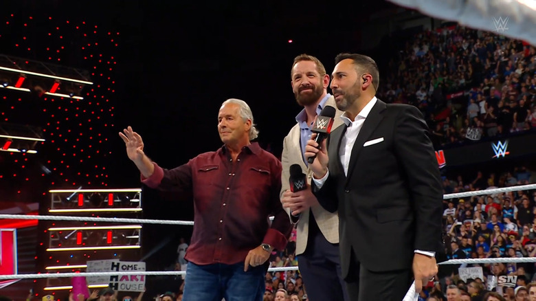 Hart, Tessitore, and Barrett in the ring