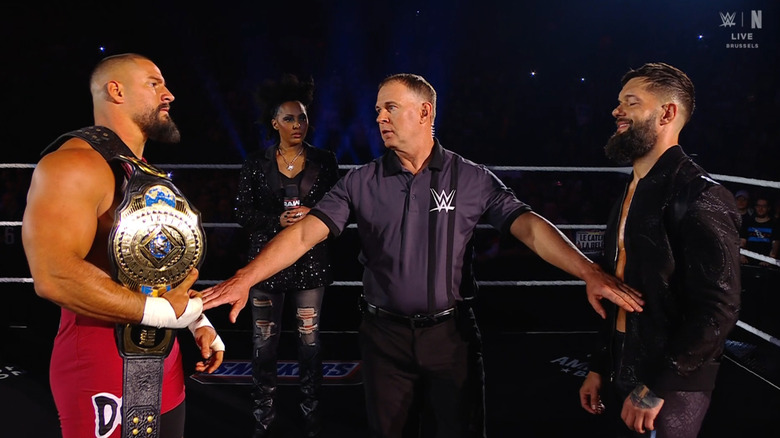 Breakker and Balor staring each other down in the ring