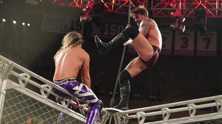 Seth Rollins and CM Punk fight atop the cage