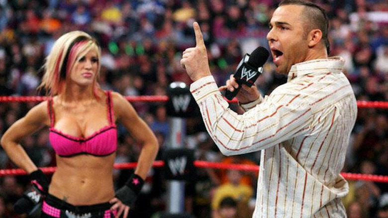 Santino Marella talks on the microphone with Ashley Massaro beside him at WWE Royal Rumble 2008