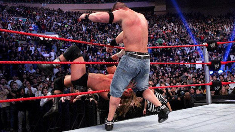 John Cena hits the F-U on Triple H, sending him out of the ring at WWE Royal Rumble 2008.