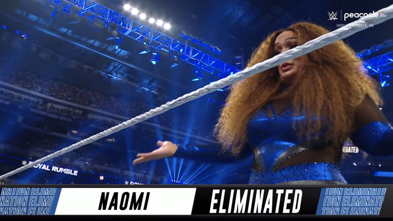 Nia Jax shrugs as a graphic reads "Naomi Eliminated"