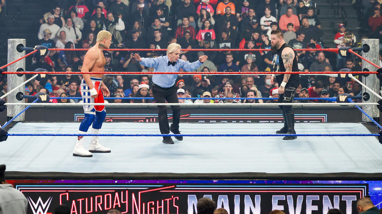 Cody Rhodes and Kevin Owens face off as the ref starts the main event on Saturday Night's Main Event