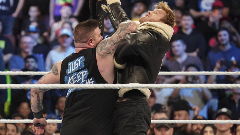 Kevin Owens punching Logan Paul