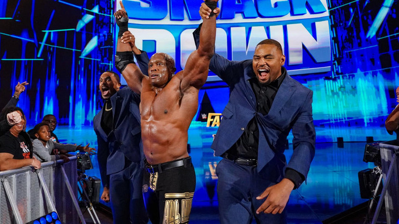 The Street Profits raise Bobby Lashley's arms