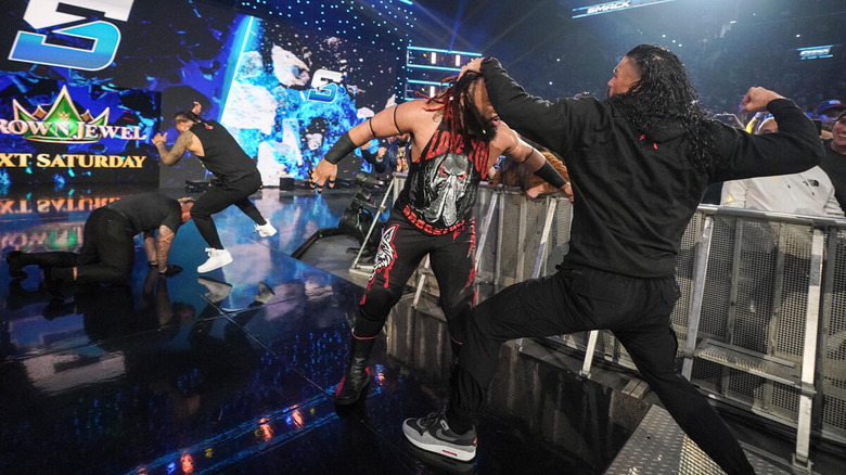 Roman Reigns fighting Jacob Fatu while Jimmy Uso fights Solo Sikoa