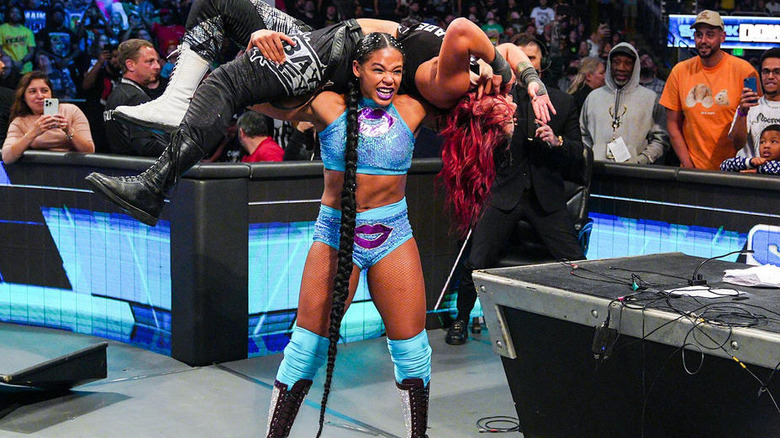 Bianca Belair with Bayley on her shoulders 