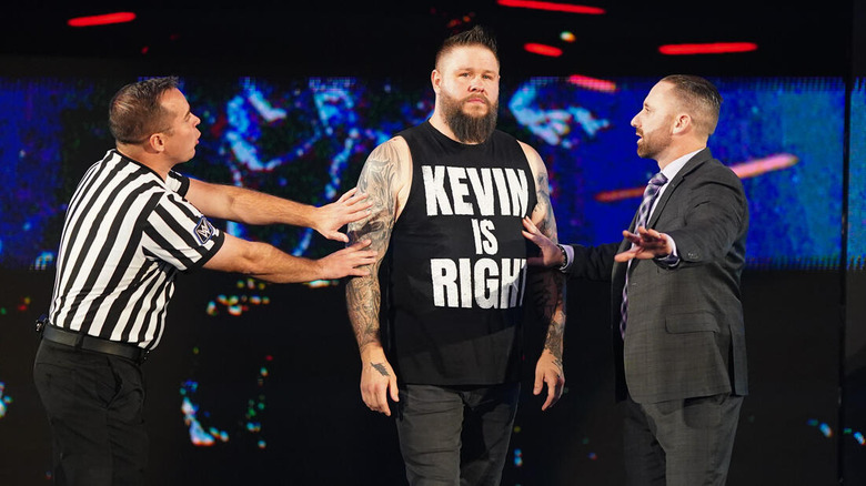 WWE officials attempt to hold back Kevin Owens on "SmackDown."