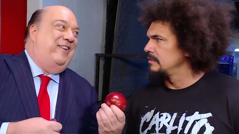 Paul Heyman offering Carlito an apple