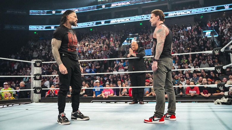 Roman Reigns stares down CM Punk as Paul Heyman looks on on "WWE SmackDown."