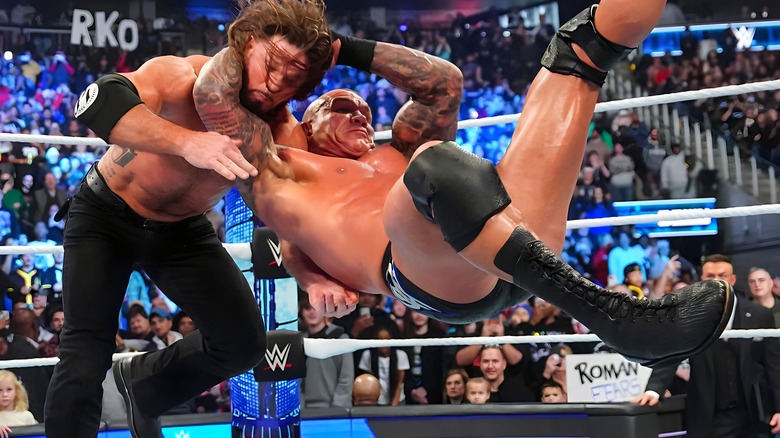 Randy Orton delivering an RKO to AJ Styles