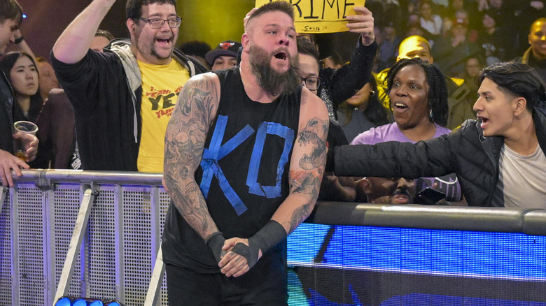 Kevin Owens clutching his hand