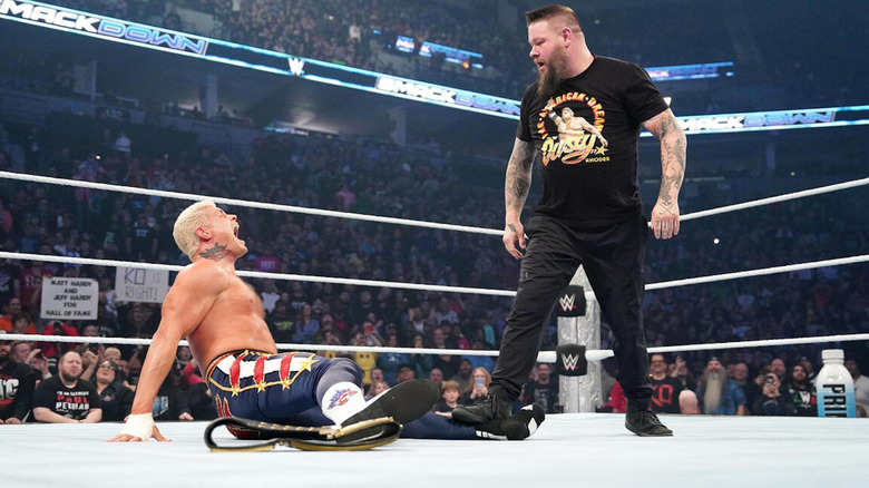 Kevin Owens steps on a chair, pressing it against Cody Rhodes' injured ankle on "WWE SmackDown"