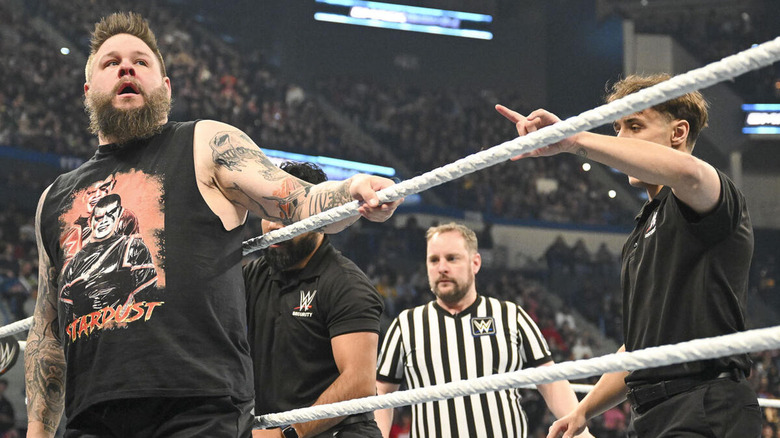 Kevin Owens standing on the ring apron wearing Stardust shirt on "WWE SmackDown."