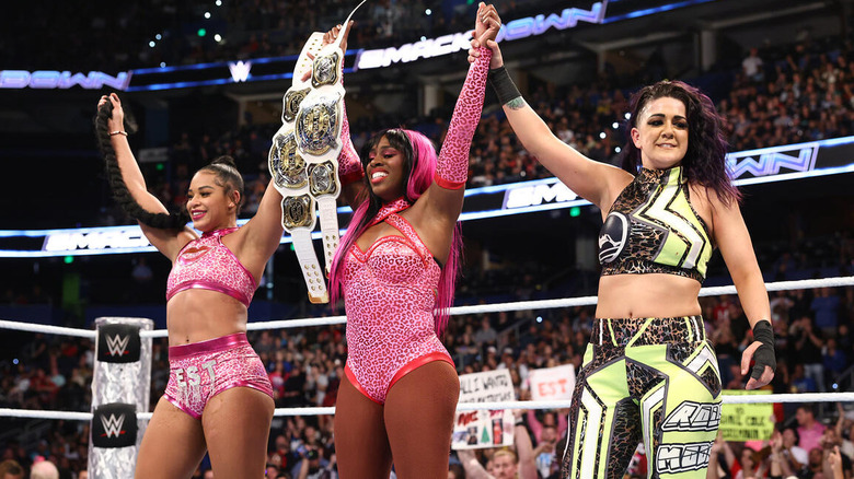 Bianca Belair, Naomi, and Bayley celebrate in the ring on "WWE SmackDown."