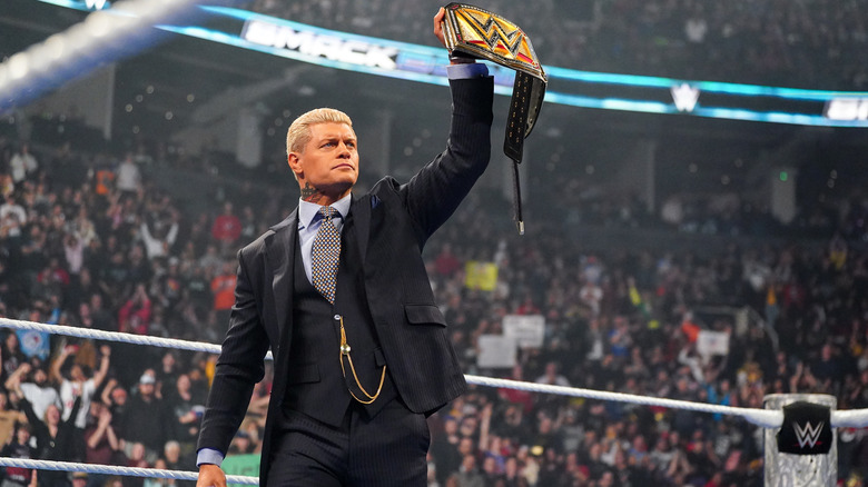 Rhodes holding up his Undisputed WWE Championship in the ring