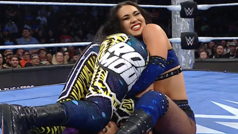 Roxanne Perez shuts her eyes as she goes in for a pin on Bayley following Pop Rox.