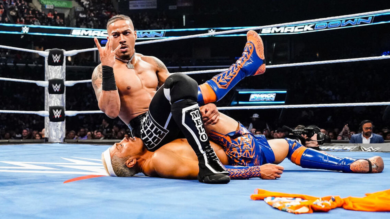 Carmelo Hayes poses while pinning Akira Tozawa on "WWE SmackDown."