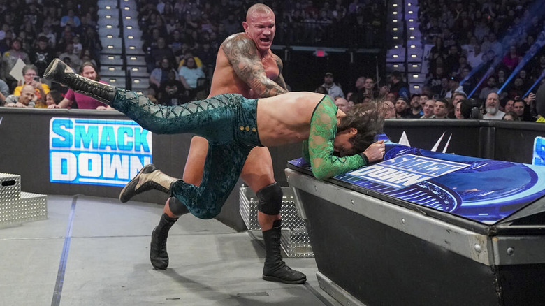 Randy Orton slams Kit Wilson's face into the announce table