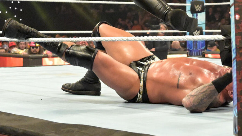 Randy Orton's leg draped over the bottom rope