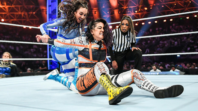 Chelsea Green drives a knee into Bayley's back