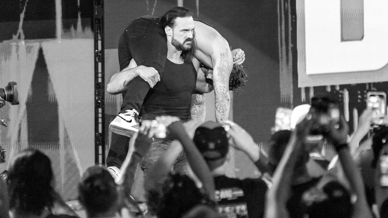 Drew McIntyre carries a bloodied CM Punk on his shoulders