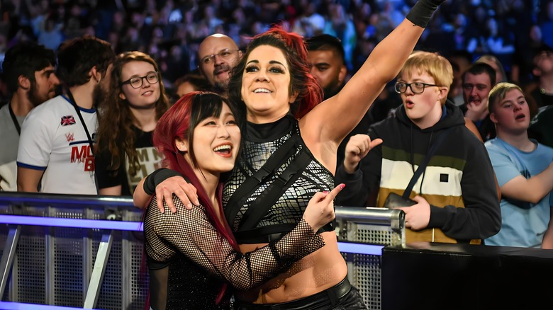 Bayley points while hugging IYO SKY