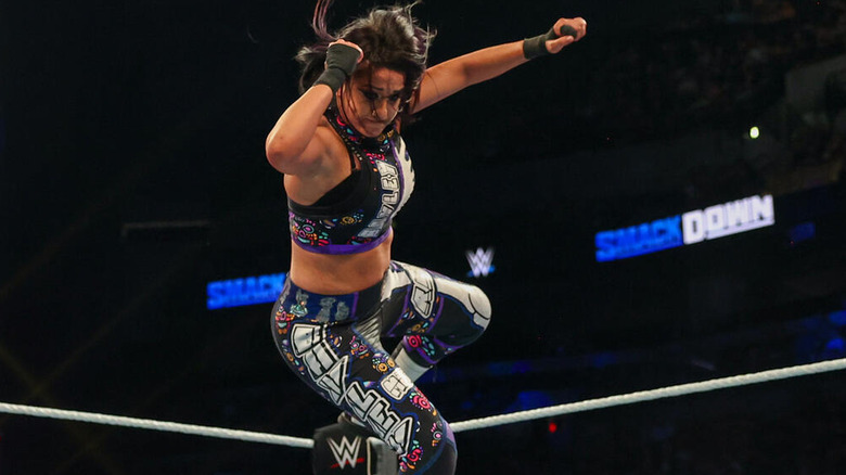 Bayley delivering a flying elbow drop