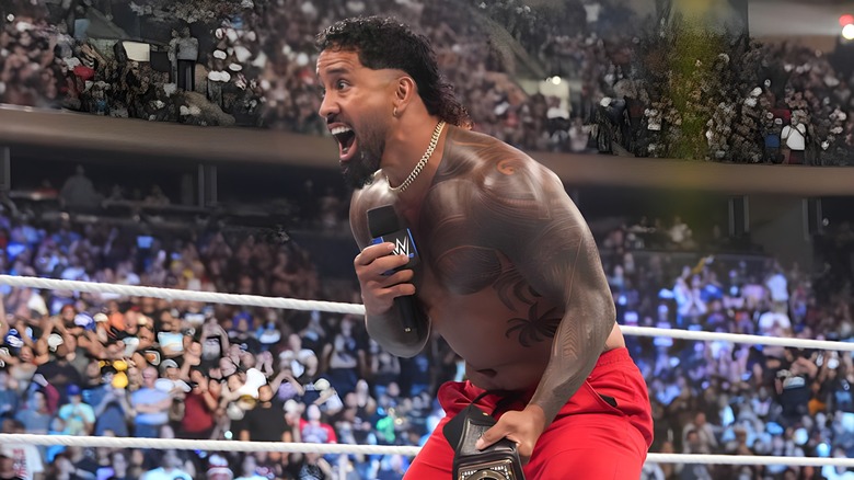 Jey Uso screams into microphone