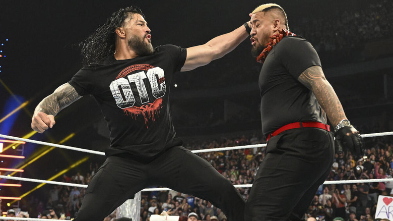 Roman Reigns punching Solo Sikoa