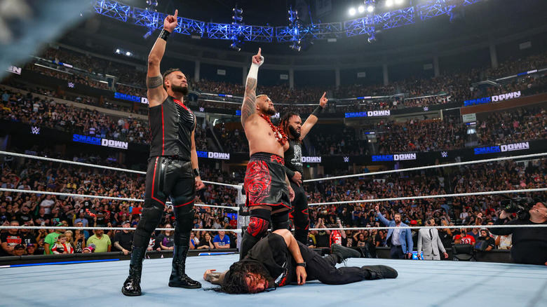 The Bloodline posing over Roman Reigns