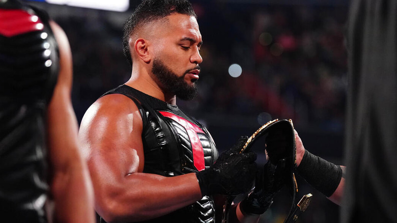 Tanga Loa stares at tag title belt