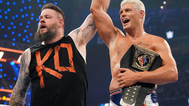 Kevin Owens holding up Cody Rhodes' arm