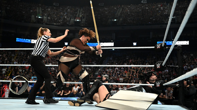 Nia Jax attacks with a Kendo Stick