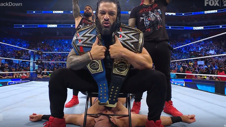 Reigns sitting on a chair over McIntyre