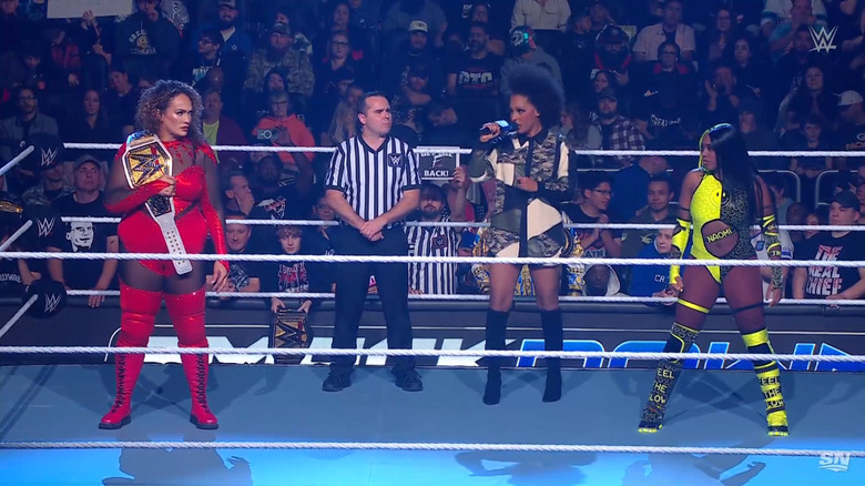 Jax and Naomi in the ring staring each other down