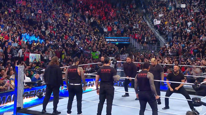 The Bloodline, Reigns, Zayn, and The Usos staring each other down