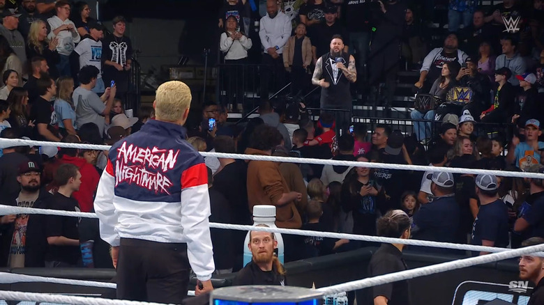 Rhodes and Owens staring each other down in the ring