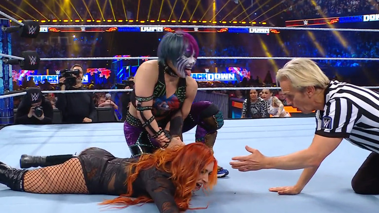Asuka with Lynch in a hold