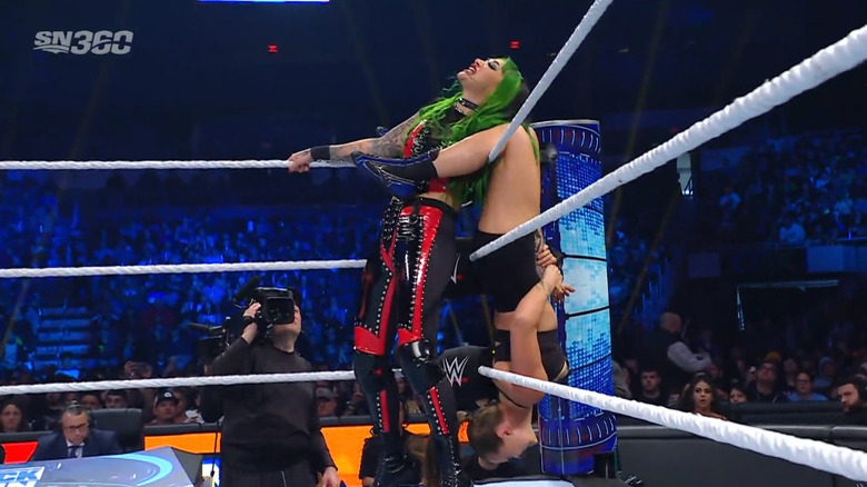 Rousey tangling up Shotzi in the ropes