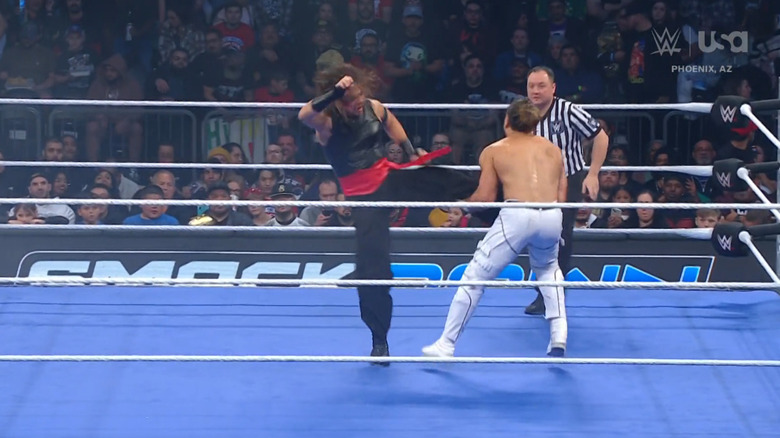 Nakamura delivering a kick to Andrade