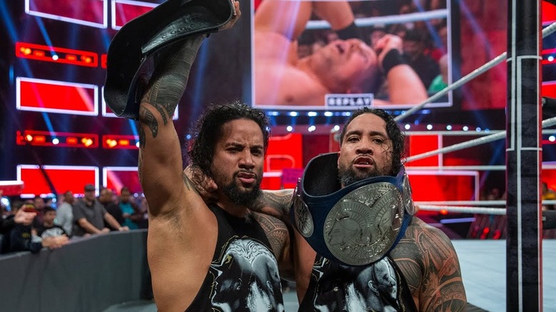 The Usos pose with their titles 