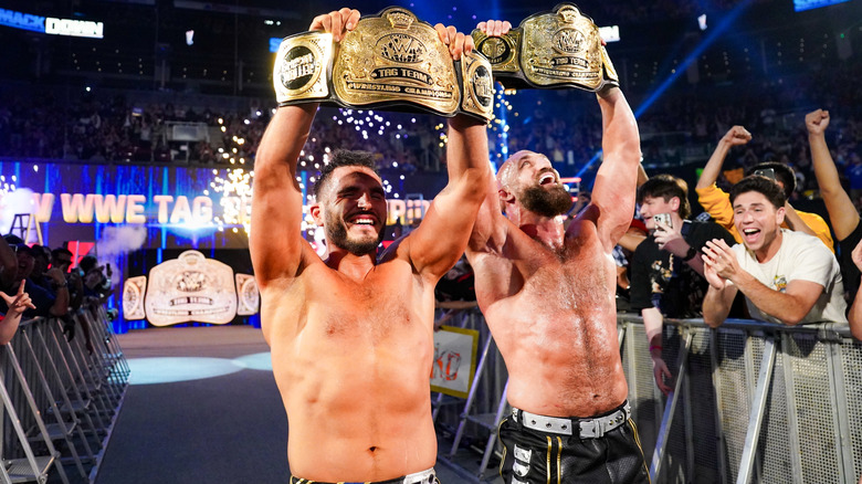 #DIY holding up their WWE Tag Team Championship belts