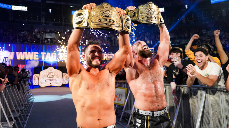 #DIY holding up their WWE Tag Team Championship belts