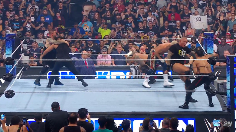 The Bloodline brawling with Owens, Orton, and Rhodes in the ring