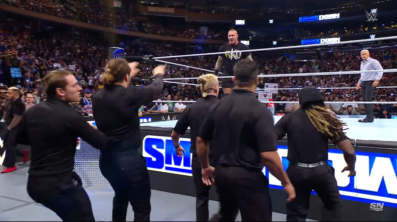 Orton and Rhodes in the ring as security stops them