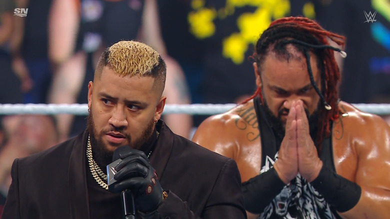 Sikoa in the ring as Fatu stands behind him